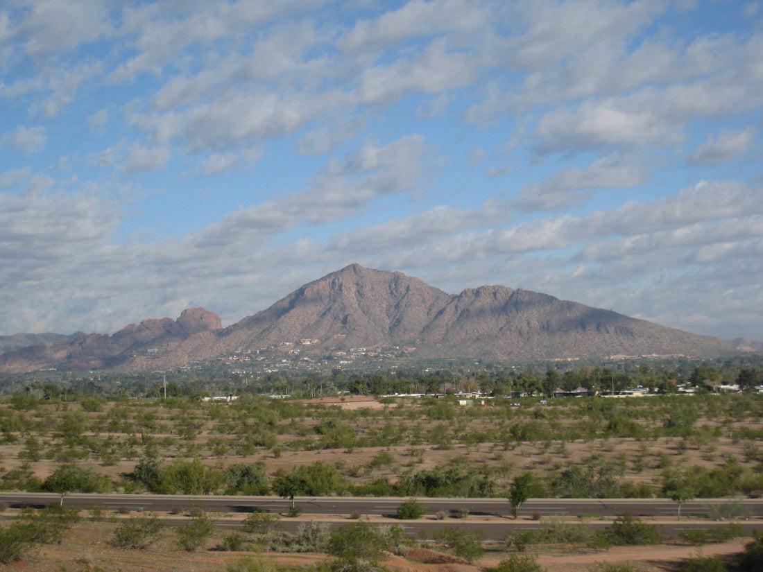 Camelback Mountain rising over the desert under a partly cloudy sky