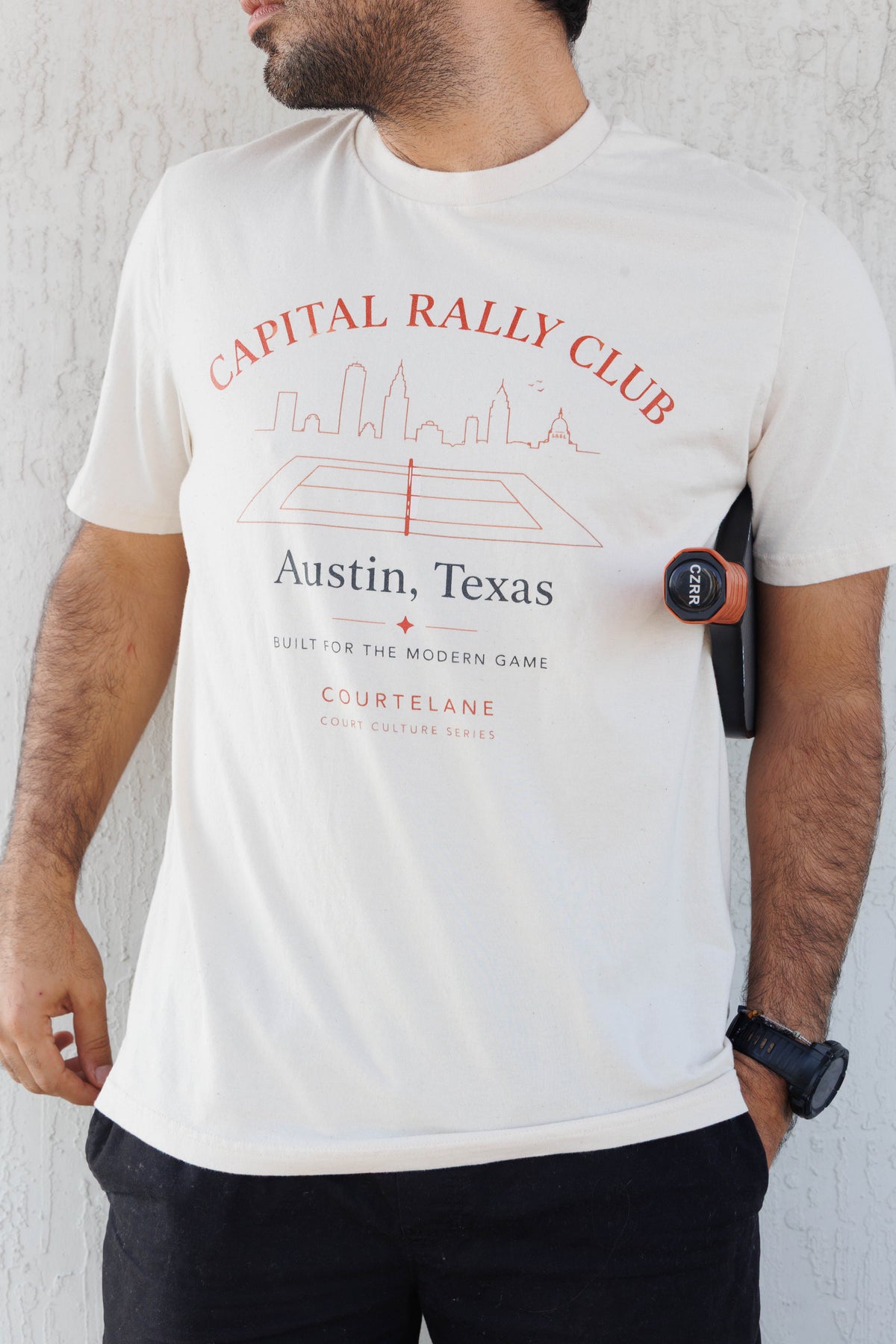 Close up of the Capital Rally Club Austin Texas print on the Courtelane men's tee