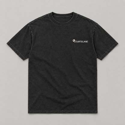 Patience Wins the Kitchen pickleball tee by Courtelane in washed black, front with small Courtelane logo